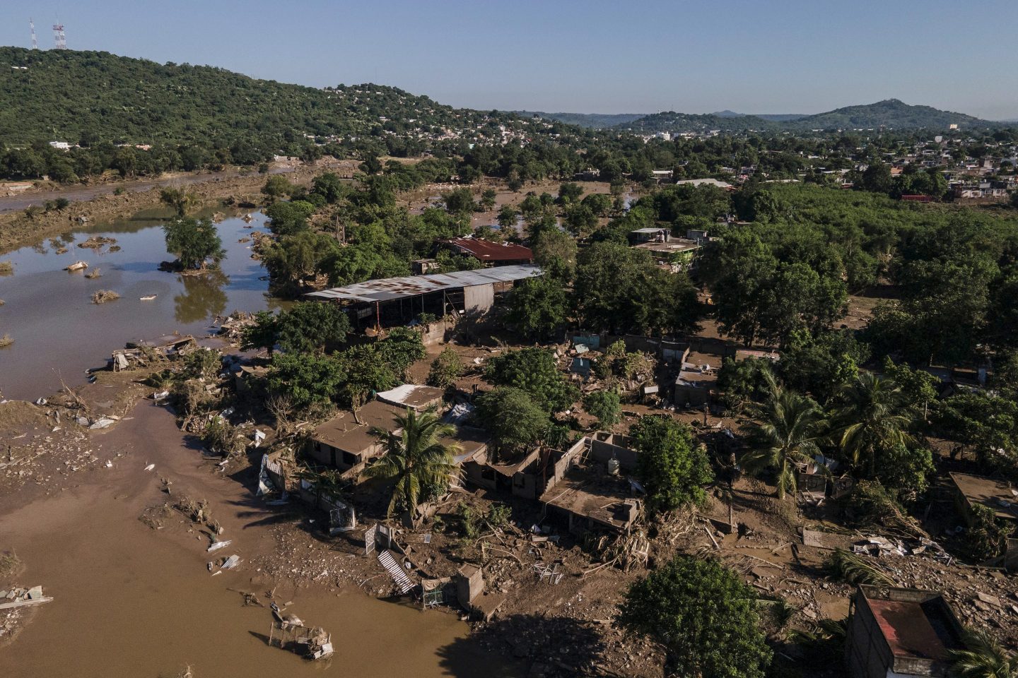 Houses sit damaged after flooding in Poza Rica, Veracruz state, Mexico, Sunday, Oct. 12, 2025.