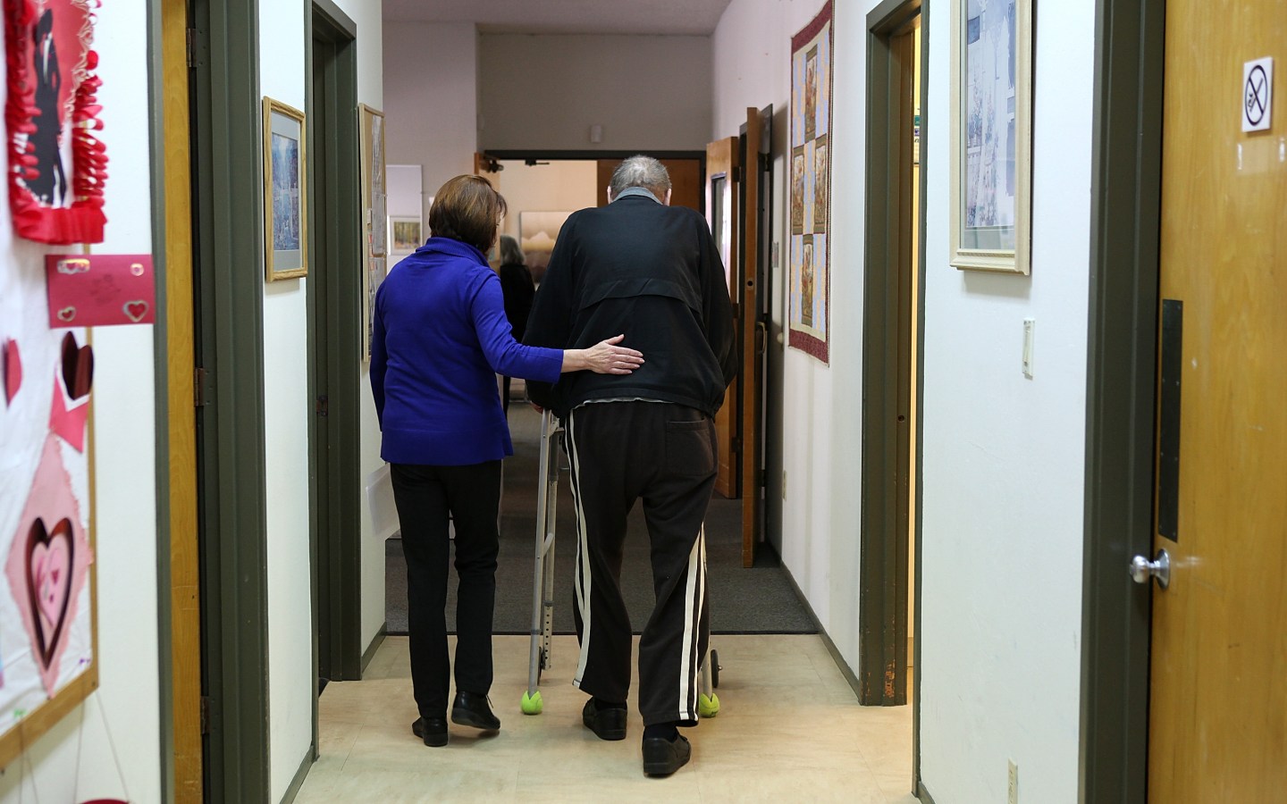 Occupational therapist Mary Tappan (L) helps a patient to a physical therapy session at the Lifelong Medical Marin Adult Day Health Care Center on February 10, 2011 in Novato, California.