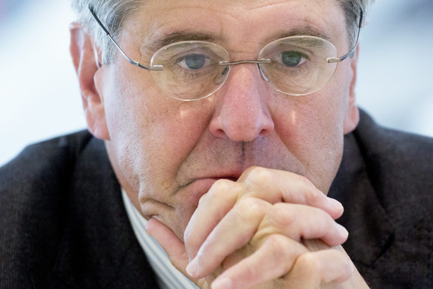 Stephen Moore looking worried, his hands clasped as if in prayer