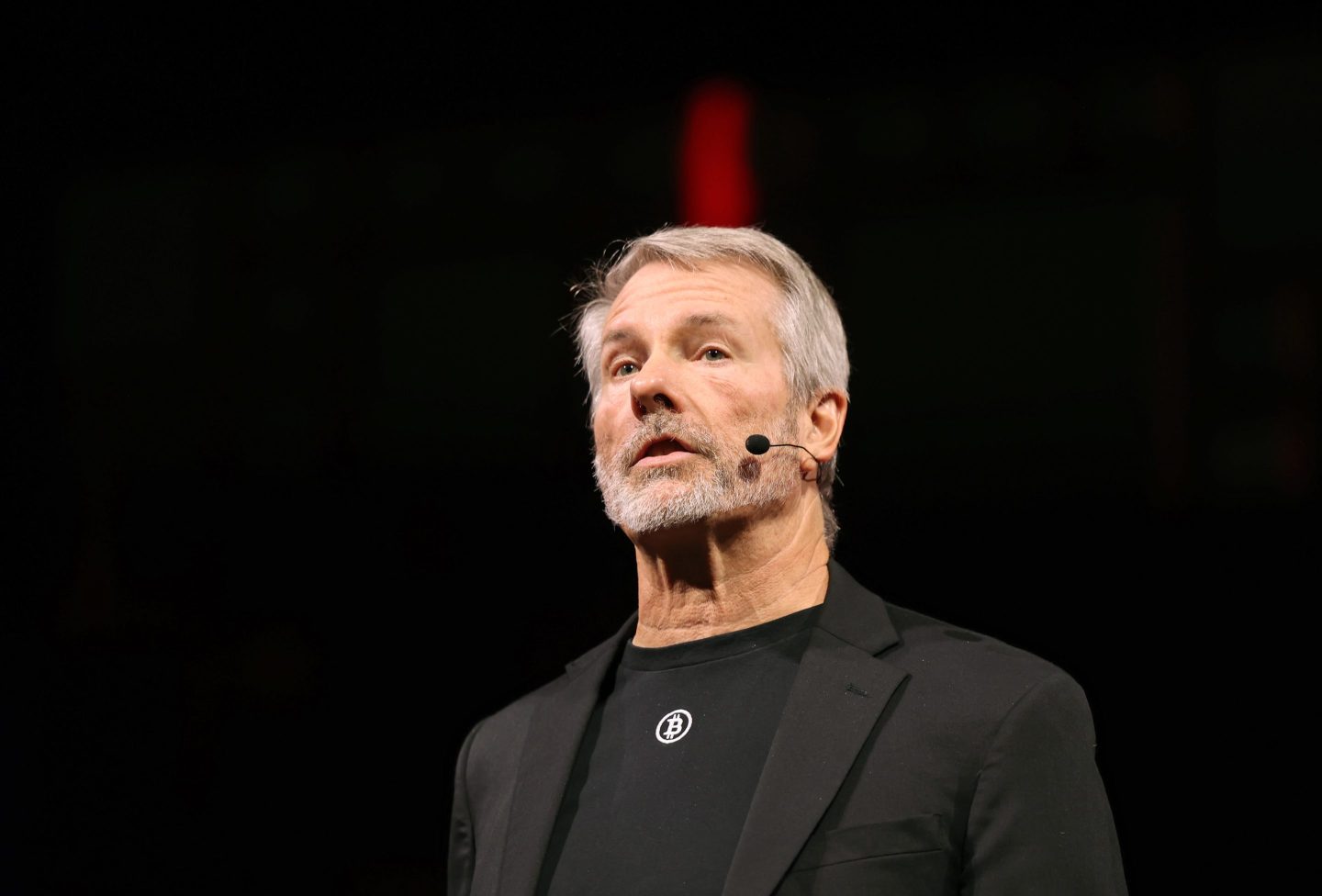 Man wearing a black suit with a microphone