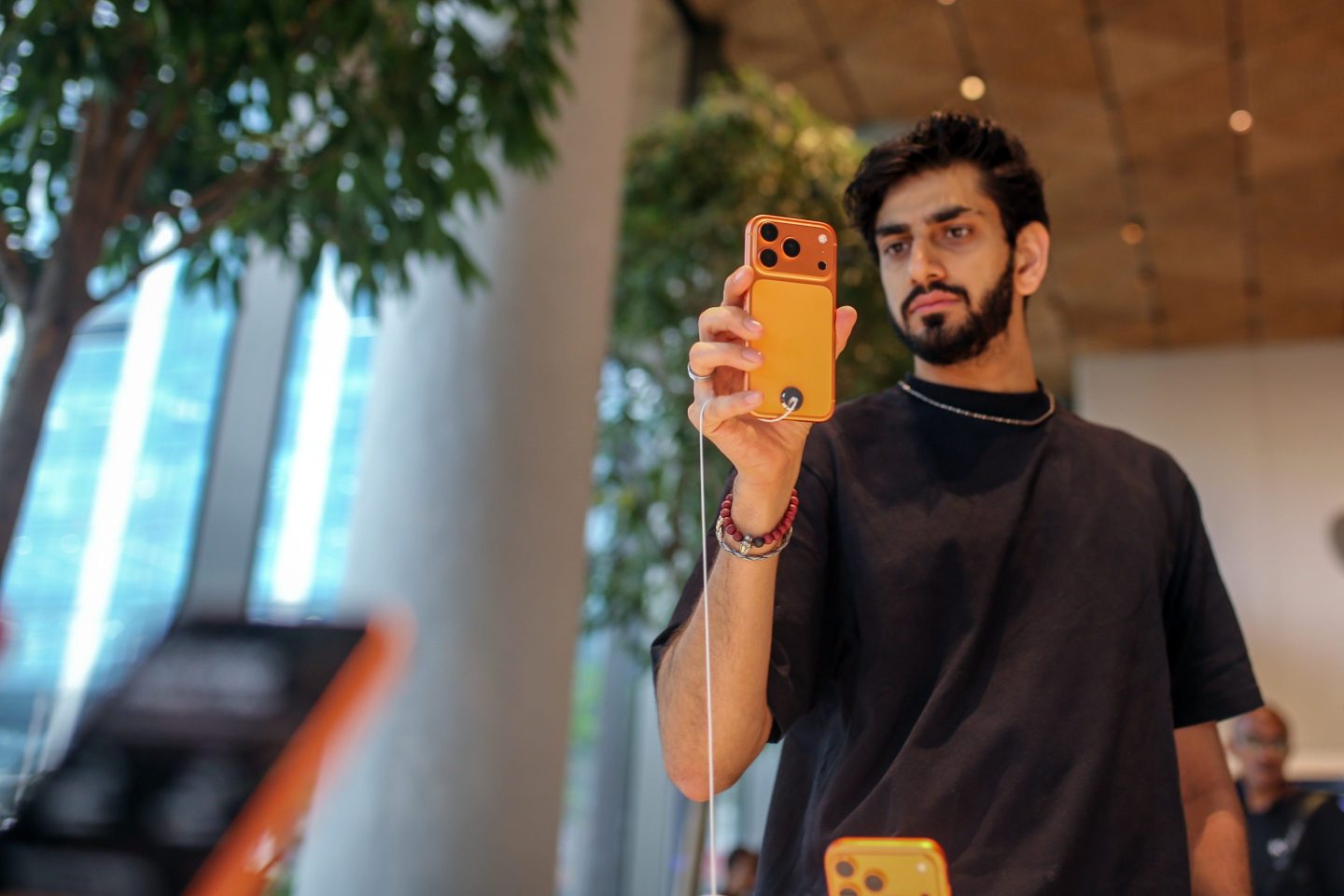 A customer looks at an Apple Inc. iPhone 17 Pro series smartphone at one of the company's stores during the first day of sales of the smartphones in Mumbai, India, on Friday, Sept. 19, 2025.