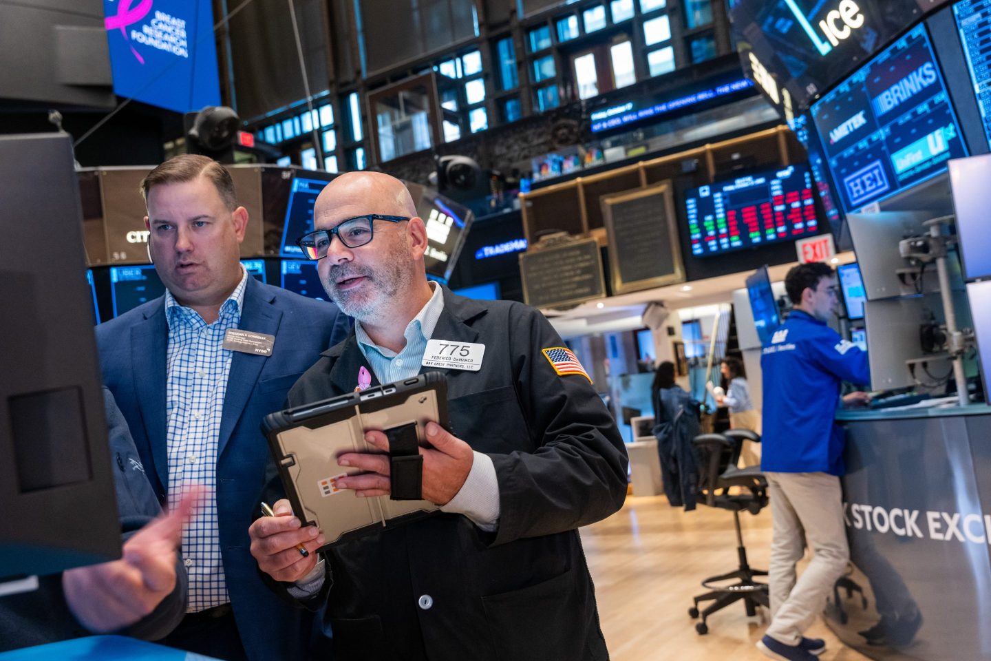 Traders work on the floor of the New York Stock Exchange (NYSE) on October 17, 2025 in New York City.